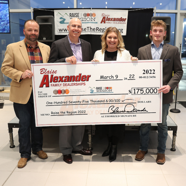 FCFP CEO, Jen, receiving a check from 4 Blaise Alexander representatives for Raise the Region in the amount of $150,000