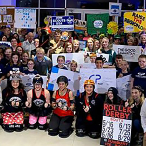 Large group of kids and teens from numerous non-profit organizations, posed while holding signs in support of fundraising for Raise the Region